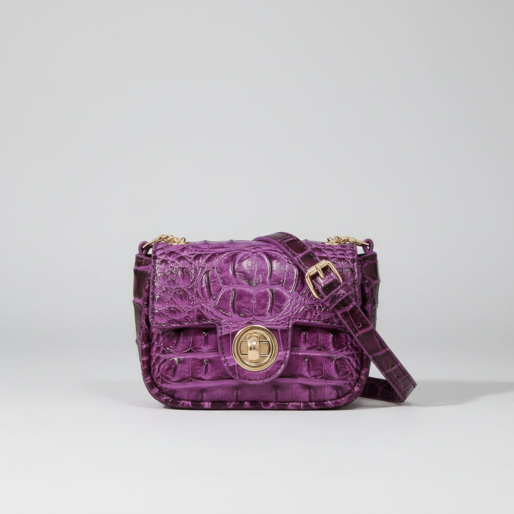 Purple textured handbag on a wooden surface with a dark background