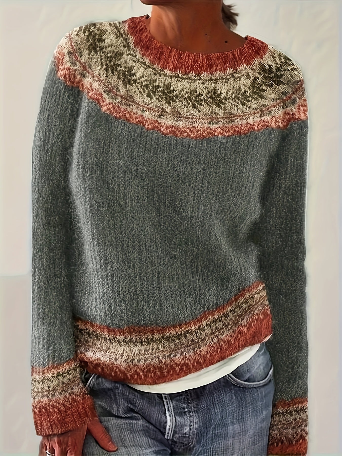 Person wearing a patterned sweater with a neutral background